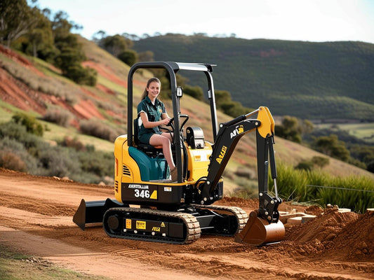 Compact excavator operated by a young woman on a dirt construction site surrounded by hills
