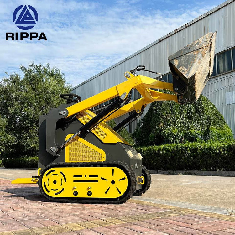 Compact Skid Steer loader with articulated arm and bucket on a construction site
