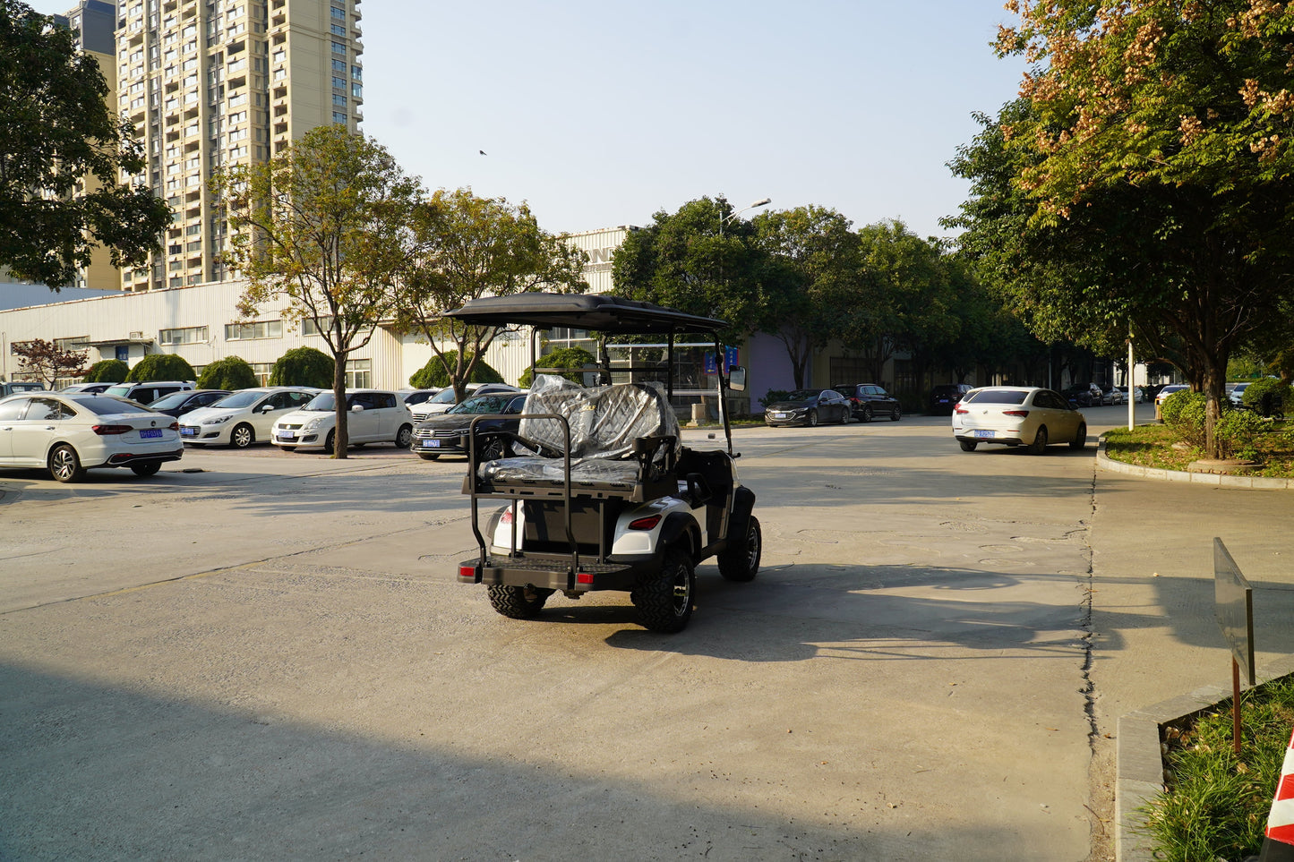 Labadi Engineering Golf Cart parked on a sunny street surrounded by cars and greenery