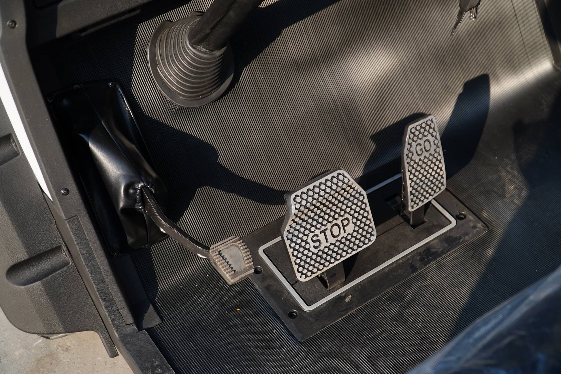 Golf Cart foot control area showing GO and STOP pedals for easy maneuvering