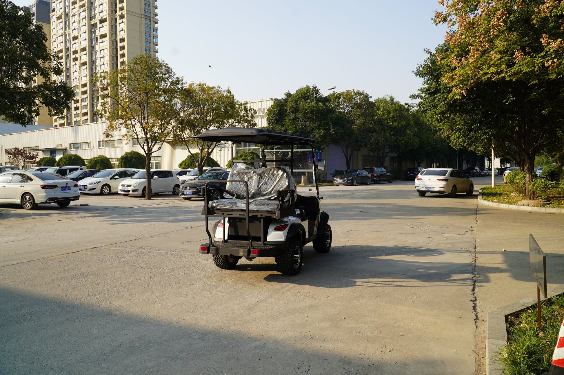 Labadi Engineering Golf Cart parked on a sunny street surrounded by cars and greenery