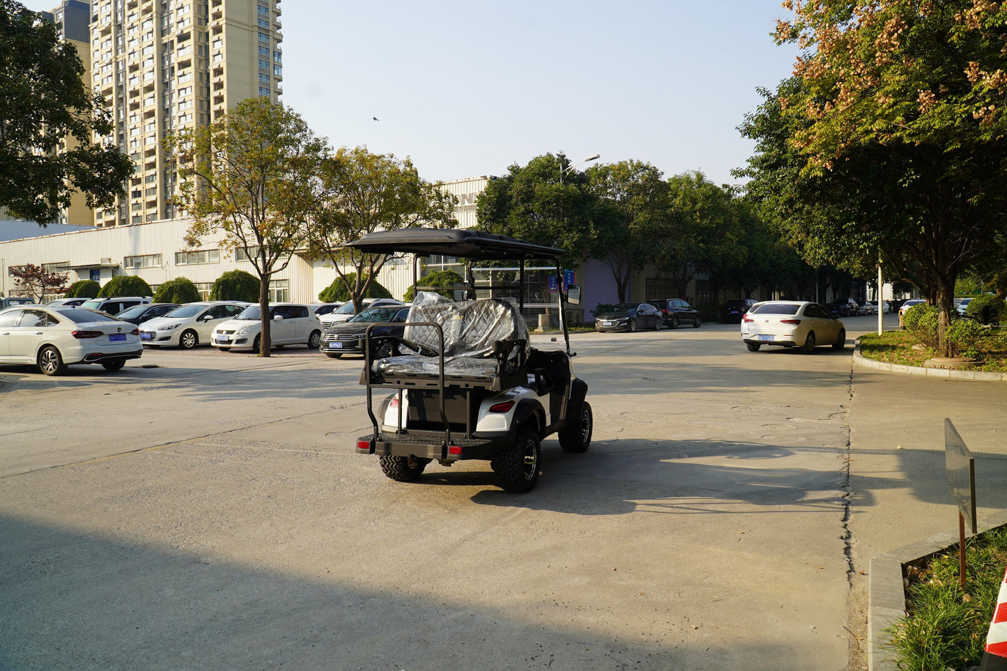 Labadi Engineering Golf Cart parked on a sunny street surrounded by cars and greenery