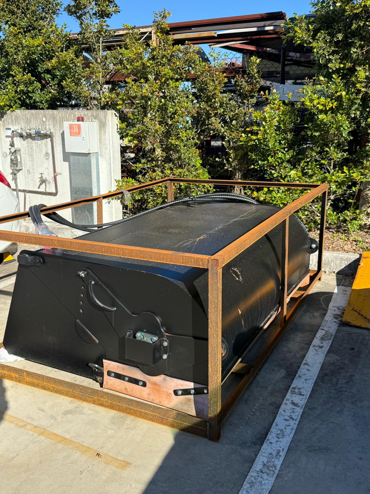 Labadi Engineering Hydraulic Skid Steer Sweeper in metal frame ready for transport or installation