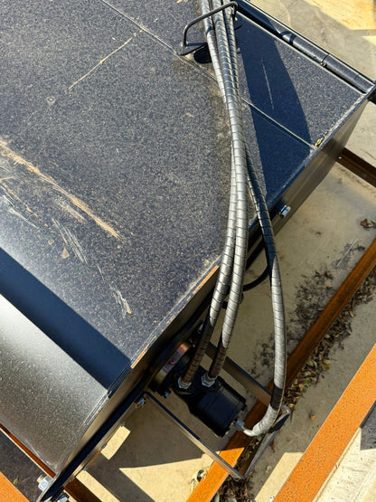 Close-up view of Labadi Engineering Hydraulic Skid Steer Sweeper showing hydraulic hoses and metal components