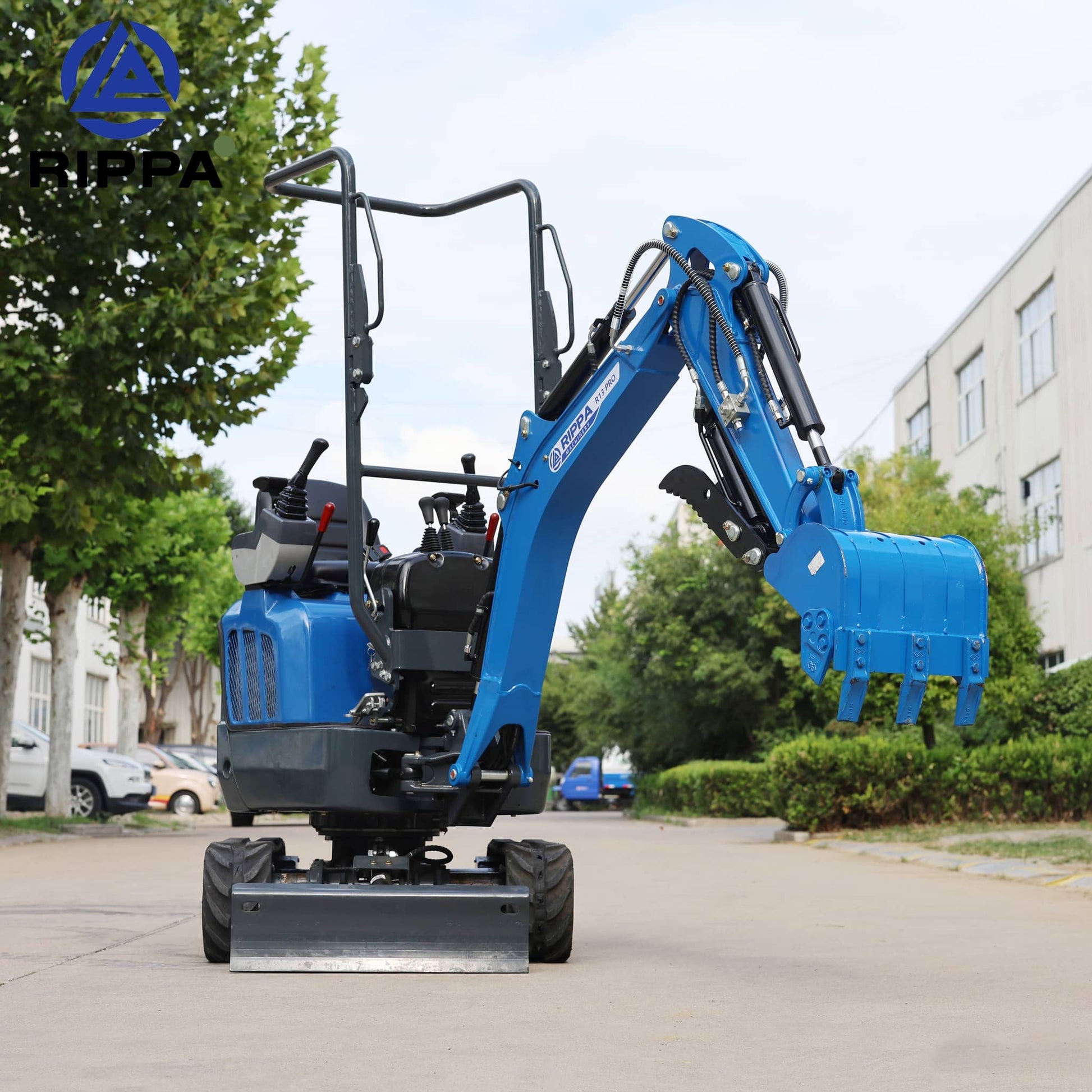 Labadi Engineering Mini Excavato in blue parked on a driveway surrounded by trees