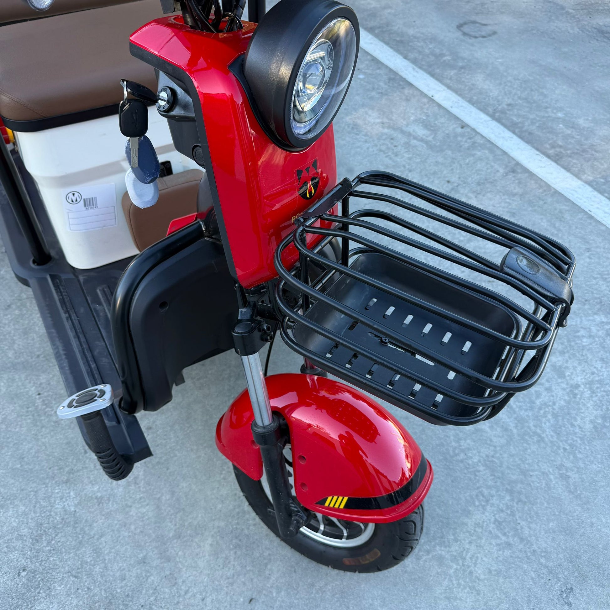 Labadi Engineering red Wheel Trike with front metal basket and headlight on concrete surface