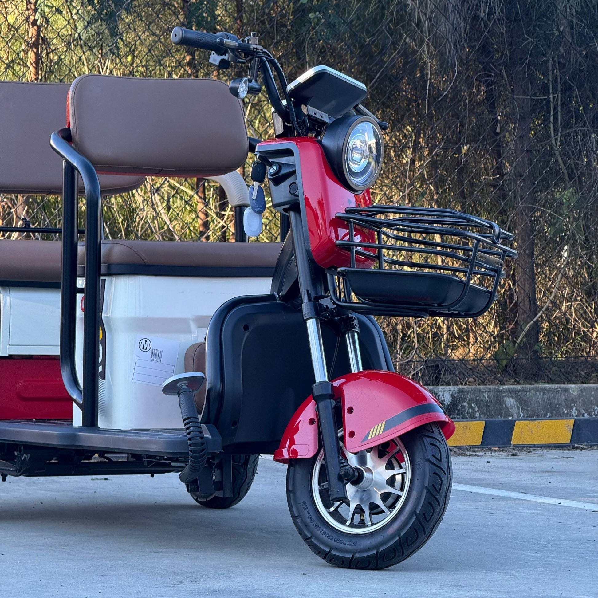 Labadi Engineering Wheel Trike in red and black with front basket and brown passenger seats